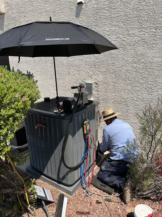 HVAC technician performing outdoor AC maintenance in Carolina Forest